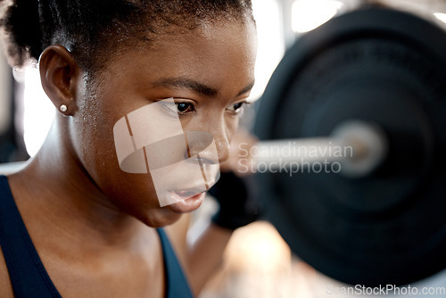 Image of Closeup, weightlifting and barbell with black woman in gym for workout, strong and muscle. Health, challenge and exercise with female bodybuilder and weights for focus, performance and commitment