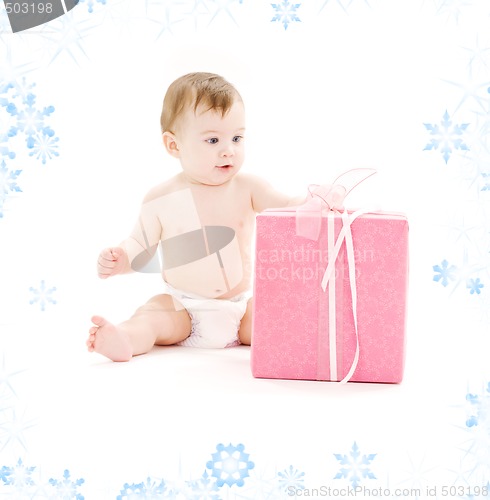 Image of baby boy in diaper with big gift box