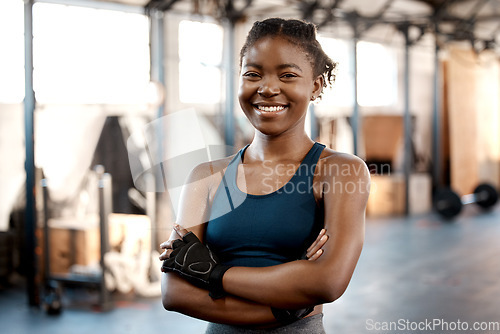 Image of Happy black woman, portrait smile and fitness with arms crossed for workout, exercise or training at the gym. Fit, active or sporty African female person or athlete smiling for healthy wellness