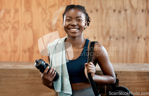 Image of Happy black woman, portrait and fitness for workout, exercise or cardio training at the gym. Fit, active or sporty African female person or athlete with smile and towel for healthy wellness indoors