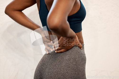 Image of Back pain, fitness and closeup of black woman in gym for muscle, ache and inflammation. Healthcare, emergency and accident with body of female athlete for burnout, sports injury and spine problem