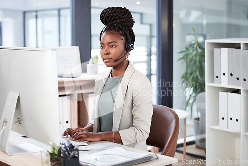 Image of Call center, computer and black woman typing for telemarketing, customer service or support. Contact us, crm or African female sales agent, consultant or person focus on business in help desk office.