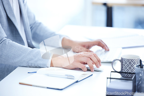 Image of Keyboard, hands and closeup of a woman typing on computer for research in the office. Technology, professional and female employee working on corporate project with desktop and notebook in workplace.