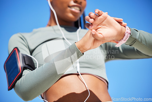 Image of Fitness, smart watch and black woman with progress, outdoor or checking time with workout goal, training or earphones. Female person, girl or athlete with tracker, activity or cellphone with practice