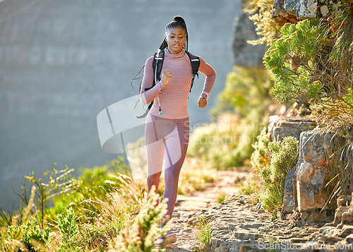 Image of Black woman, mountain running and outdoor for fitness, speed or challenge for wellness with focus in summer. African girl, workout and runner training in sunshine with exercise, adventure and hiking