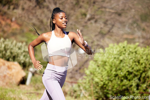 Image of Black woman, mountain running and nature for fitness, speed or challenge for wellness with focus in summer. African girl, workout and runner training in sunshine with exercise, adventure and hiking