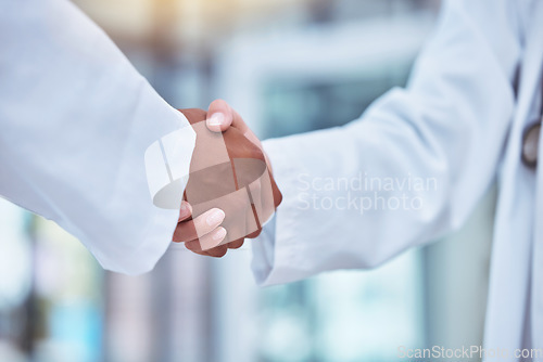 Image of Closeup, doctors and handshake in hospital for partnership, deal and collaboration for wellness, healthcare and respect. Medic team, shaking hands and welcome for interview, hiring and recruitment