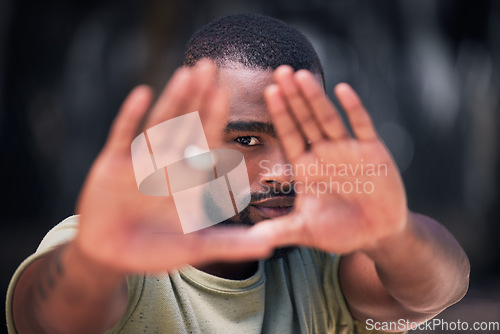 Image of Hand frame, style and portrait of a black man in a city with fashion, styling and modern clothing. African male person, urban and hands of a model from Texas with gen z, cool and hipster shirt