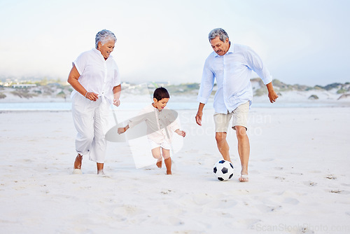 Image of Beach, football and grandparents playing with kid on vacation or holiday happy for sand soccer or sports. Travel, summer and elderly man and woman kicking a ball with child at the ocean together