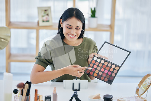 Image of Makeup pallet, influencer and happy woman streaming tutorial for cosmetics, social media or skincare. Make up artist, live stream and content creator with smile, product broadcast and beauty channel.