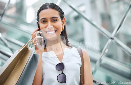 Image of Phone call, face and a woman with a shopping bag on mall escalator for fashion, sale or discount deal. Portrait of female person or happy customer talking on smartphone for retail promotion chat