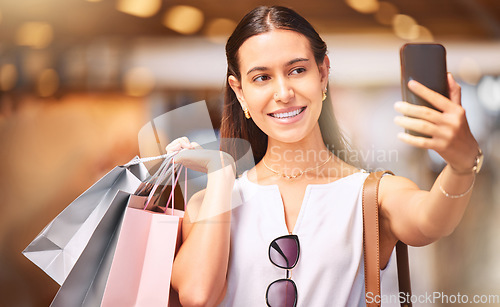 Image of Selfie, shopping bag and a woman with a smile in mall for fashion, sale or influencer discount deal. Person or happy customer with retail bags and smartphone for online promotion and ambassador photo