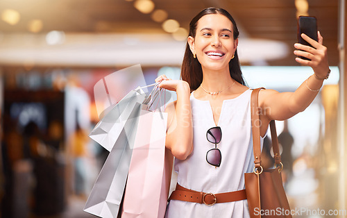 Image of Selfie, smile and a woman with a shopping bag in mall for fashion, sale or influencer discount deal. Person or happy customer with retail bags and smartphone for online promotion and ambassador photo