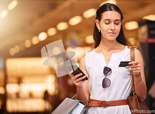 Image of Credit card, phone and a woman with a shopping bag in mall for fashion, sale or discount deal. Female person or happy customer with retail bag for online promotion offer and mobile banking app mockup