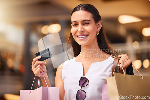 Image of Credit card, smile and a woman with a shopping bag in mall for fashion, sale or discount deal. Portrait of female person or happy customer with retail bags for promotion offer and bank payment