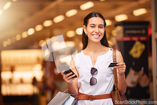 Image of Phone, credit card and a woman with a shopping bag in mall for fashion, sale or discount deal. Portrait of happy customer person with smartphone for retail promotion offer and online banking app