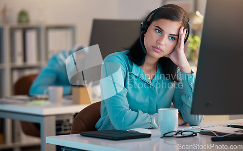 Image of Call center, bored and tired woman in office for customer service or support at night. Telemarketing, computer and fatigue of female sales agent, burnout consultant or lazy employee with crm deadline
