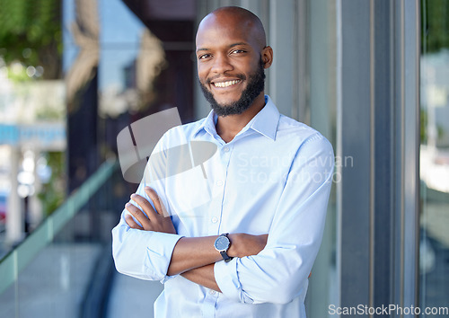 Image of Confidence, crossed arms and portrait of a businessman in the city by a office building. Success, happy and professional African male financial analyst standing outside his workplace in an urban town