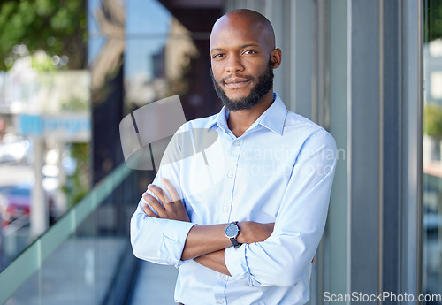 Image of Serious, crossed arms and portrait of a businessman with confidence in city by office building. Success, happy and professional African male financial analyst standing outside workplace in urban town