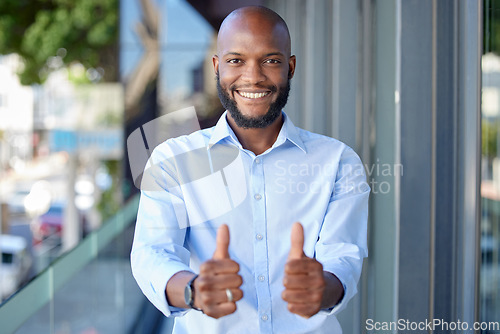 Image of Thumbs up, thank you and portrait of a black man entrepreneur happy for startup or company success in office building. Agree, yes and young employee or person with agreement sign, gesture and smile