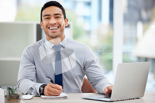 Image of Portrait, happy businessman and working in office or writing in notebook or research on laptop for corporate job. Man, smile and employee planning with notes, report or business analytics on company