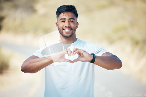 Image of Happy man, fitness and portrait with heart hands in nature for cardio health or workout exercise outdoors. Fit, active or sport male person, athlete or runner with loving emoji and smile for training