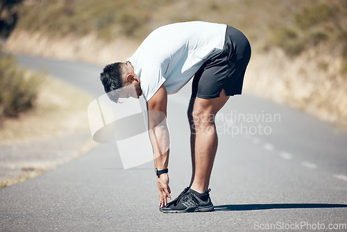 Image of Stretching, running and fitness with man in road for training, workout and exercise. Muscle, energy and cardio performance with male runner and warm up in nature for marathon, start and health