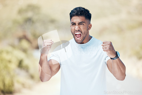 Image of Man, fitness and fist in nature for celebration, winning or achievement from workout, exercise or training outdoors. Happy and excited male person, athlete or runner in joy for cardio, win or victory