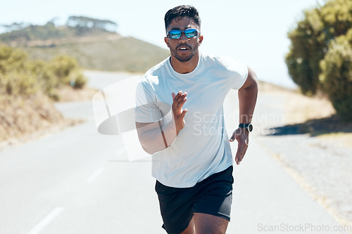 Image of Man, fitness and running in nature for workout, cardio exercise or training outdoors. Fit, active and sporty male person, athlete or runner exercising on mountain asphalt, road or street outside