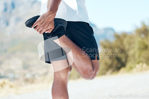 Image of Man, fitness and hands stretching legs in nature for running, cardio workout or exercise outdoors. Hand of fit, active or sporty male person, athlete or runner in warm up leg stretch for mountain run