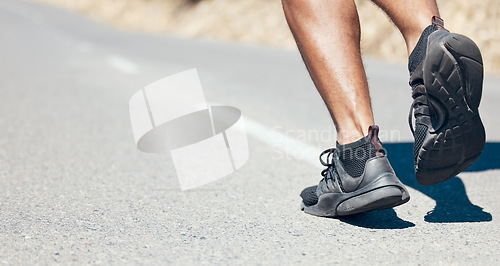 Image of Man, fitness and running shoes on road for exercise, cardio workout or training on asphalt outdoors. Feet of fit, active or sporty male person, athlete or runner exercising or run on mountain street