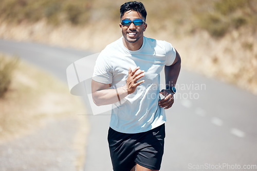 Image of Happy man, fitness and running on road for workout, cardio exercise or training in nature. Fit, active and sporty male person, athlete or runner exercising on mountain, asphalt or street run outdoors