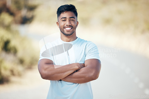 Image of Fitness, portrait and man with arms crossed on a road with happiness from run and sport. Face, smile and confidence from wellness, workout and runner exercise on a urban street outdoor feeling happy