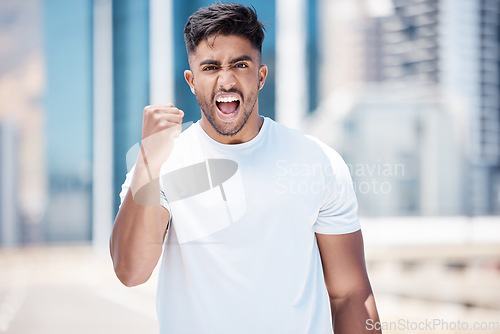 Image of Happy man, fitness and fist in city for celebration, achievement or winning in the outdoors. Excited male person, athlete or runner in joyful happiness for workout success or exercise in a urban town