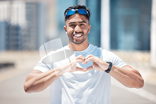 Image of Happy man in portrait, heart hands and athlete outdoor, sports and fitness with health and wellness. Healthy male person smile in city, self love and care with cardio, exercise with emoji or sign