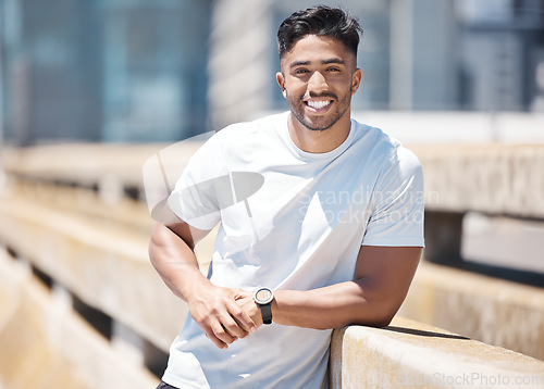 Image of Fitness, sport man and portrait in the city with break from running, workout and exercise outdoor. Urban, male person and Indian athlete with happiness, wellness and health from run for race in town