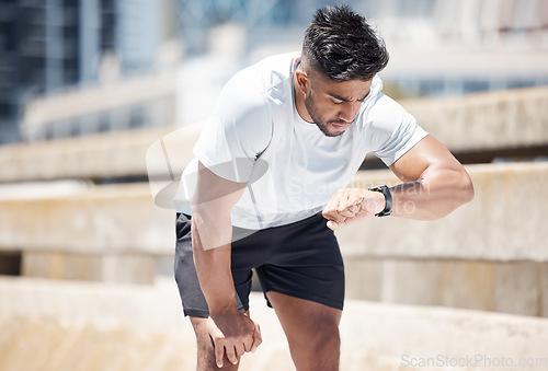 Image of Man, fitness and checking watch after running exercise, cardio workout or training in city. Fit, active and sporty male person, athlete or runner looking at wristwatch for performance in urban town