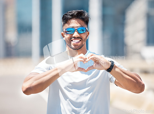 Image of Man, smile in portrait and heart hands, athlete outdoor and sports, fitness with health and wellness. Healthy male person happy in city, self love and care with cardio, exercise with emoji or sign