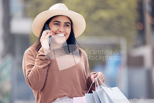 Image of Shopping, phone call and happy Indian woman in city with bag for conversation, talking and communication. Retail, fashion and female person on smartphone with bags for sale, bargain and discount