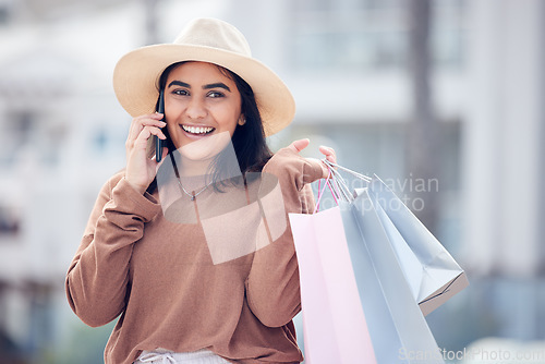 Image of Shopping, phone call and Indian woman in city with bag for communication, conversation and chat. Retail, fashion and happy female person talking on smartphone with sale, bargain and discount purchase