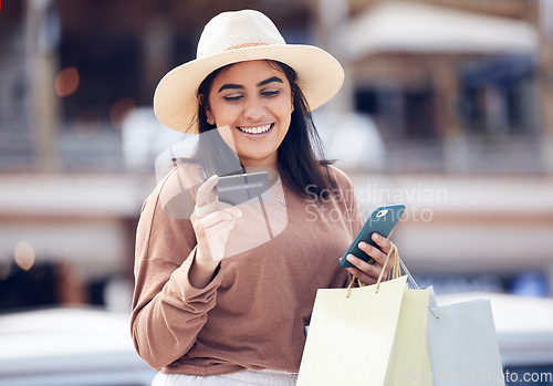 Image of Woman, smile with credit card and smartphone, shopping bag at mall with online payment and fintech. Happy female customer at outdoor market, ecommerce with bank app and internet banking transaction