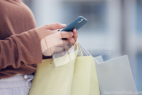 Image of Shopping, phone and hands of woman in city with bag online for bargain notification, social media and internet. Retail, fashion and female person on smartphone for chat, mobile app and website sale