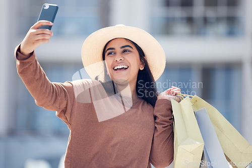 Image of Shopping, selfie and happy Indian woman in city with smile for online post, social media and internet. Retail, fashion and female person take picture with bags from bargain, sale and discount in town