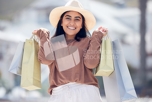 Image of Happy woman in portrait, shopping with paper bag and retail at outdoor mall, luxury purchase and shop discount. Female customer smile, fashion designer brand and buyer choice, store promotion sale