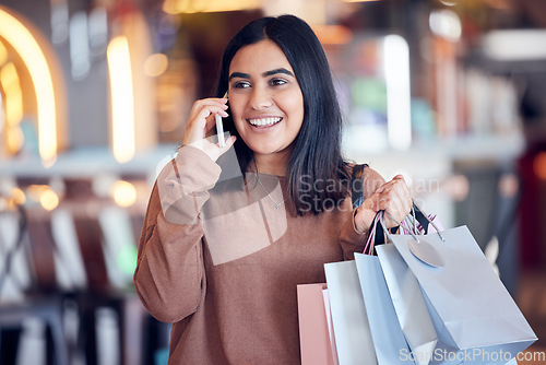 Image of Shopping, phone call and Indian woman in mall with smile for communication, conversation and chat. Retail, fashion and happy female person talking on smartphone for sale, bargain and discount news