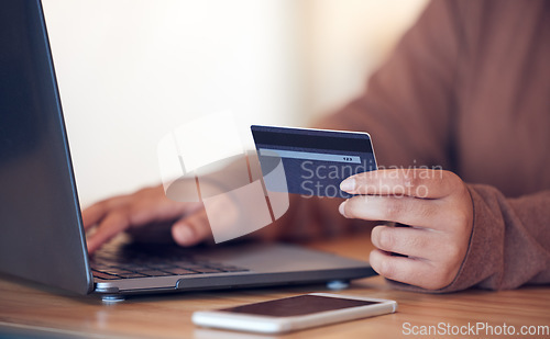 Image of Online shopping, computer and credit card with freelance worker on a ecommerce website. Person, hands and freelancer at a laptop on a digital store app for deal and discount with payment at table