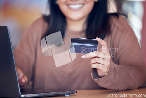 Image of Online shopping, woman hand and credit card with freelance worker on a ecommerce website. Person, hands and freelancer at a laptop on a digital store app for deal and discount with payment at table