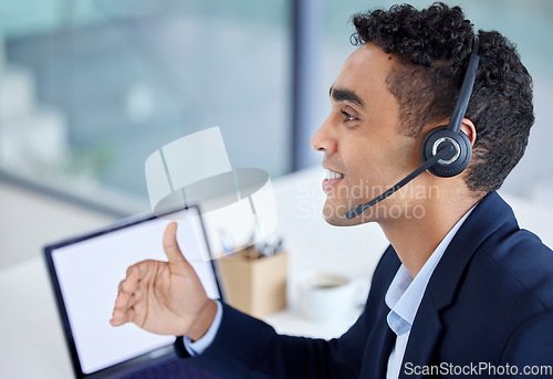 Image of Happy, call center or telemarketing agent talking in customer service office with laptop and working on computer screen. Hispanic man, businessman and consulting operator on crm and sales support