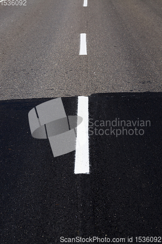 Image of part of the old and new asphalted road