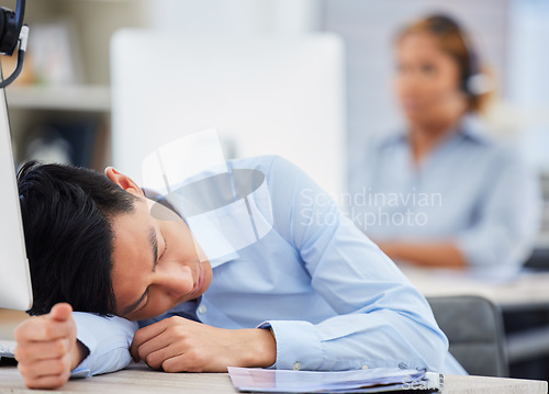 Image of Call center, burnout or tired man sleeping on table exhausted or overworked by deadlines in overtime. Resting, dreaming or lazy sales agent with stress or fatigue napping on relaxing break at desk